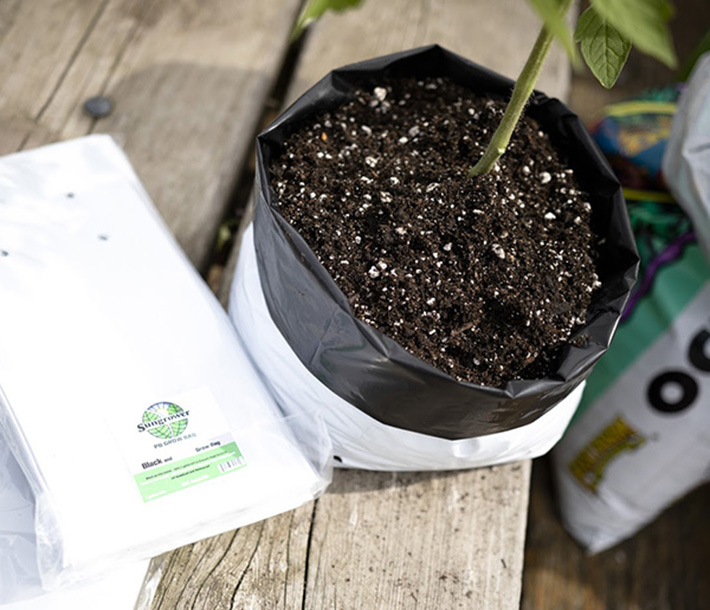 Sungrower Grow Bags are black inside and white outside, with holes to prevent excess moisture