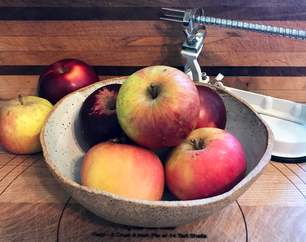 apples in a bowl on the counter
