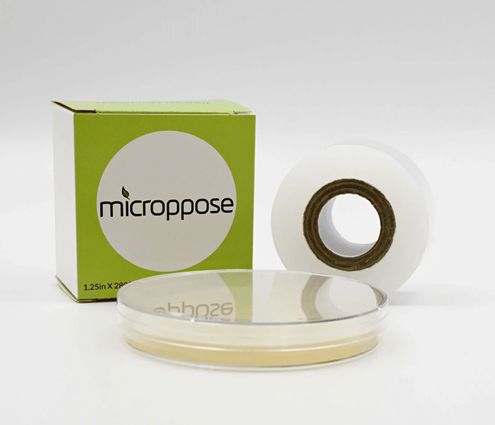 A box of clear poyfilm next to a roll of polyfilm with a petri dish covered in polyfilm in front.