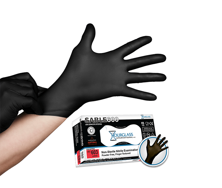 A person putting on black nitrile gloves . Small image of box of gloves in background.