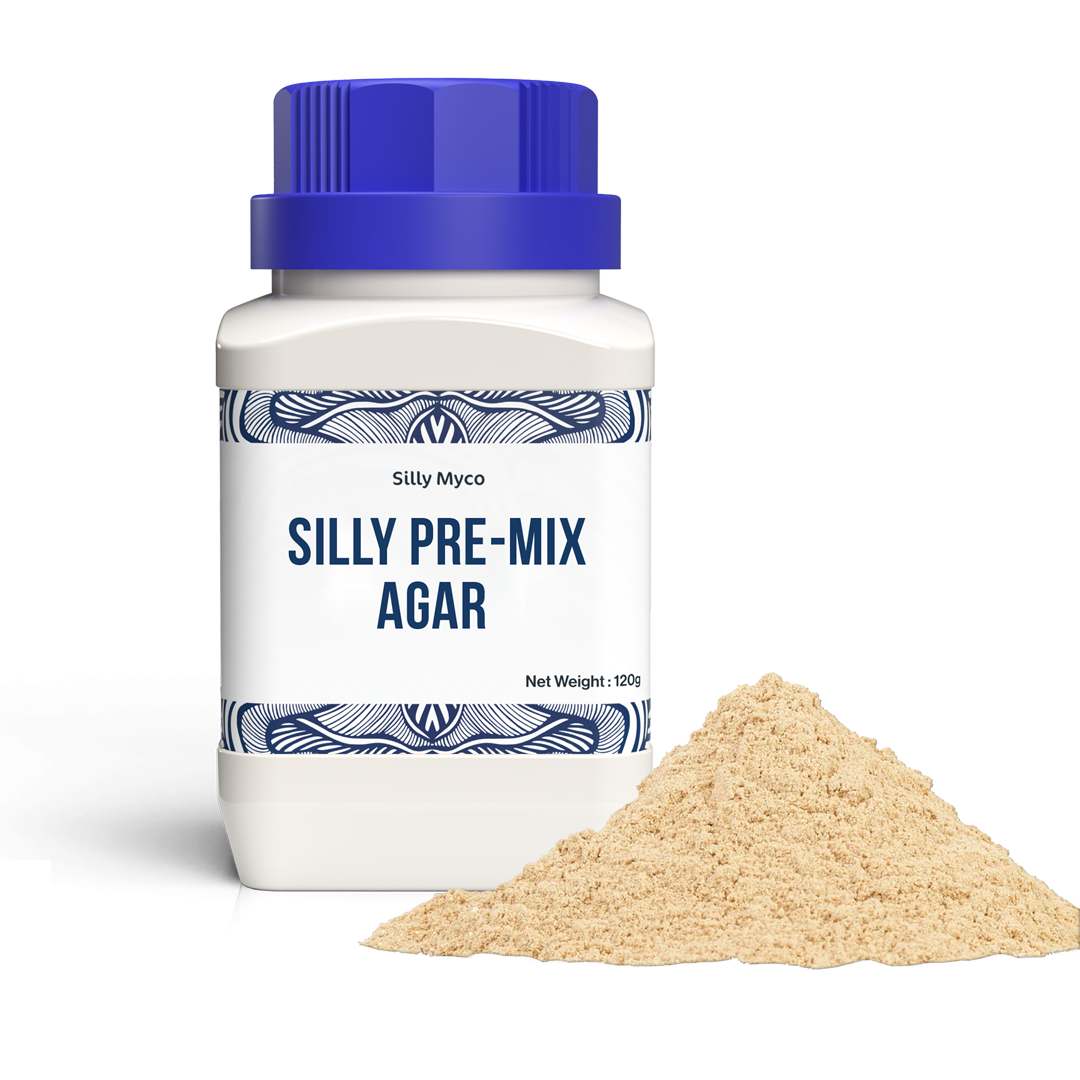 A white bottle of Silly Myco Silly Pre-Mix Agar with a blue lid beside a pile of the beige Pre-Mix Agar powder